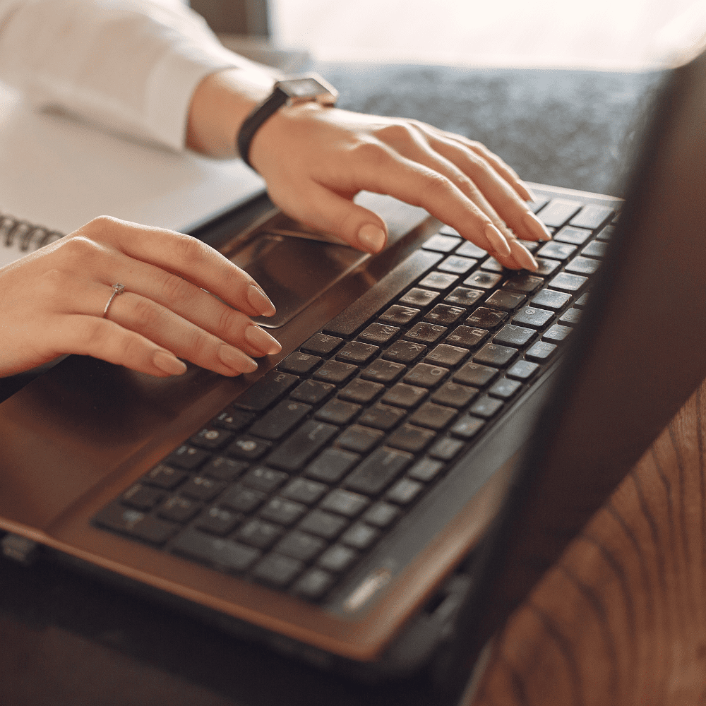 Hands on a keyboard of a laptop.